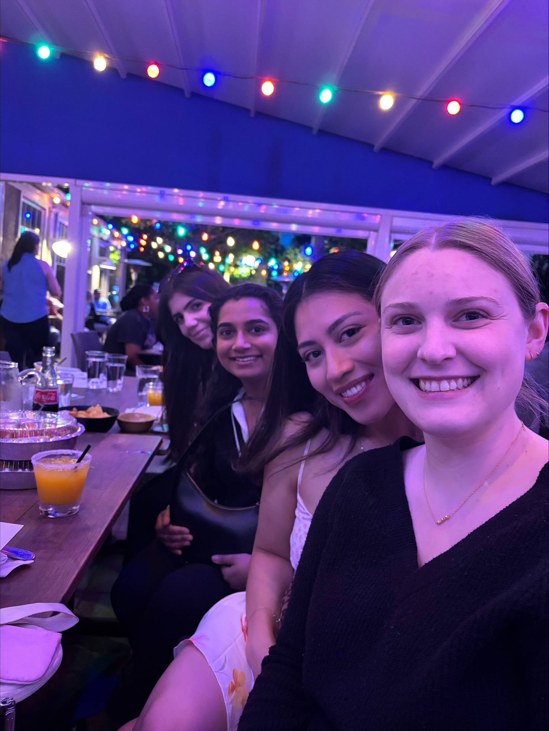 Madison and friends taking a selfie at dinner