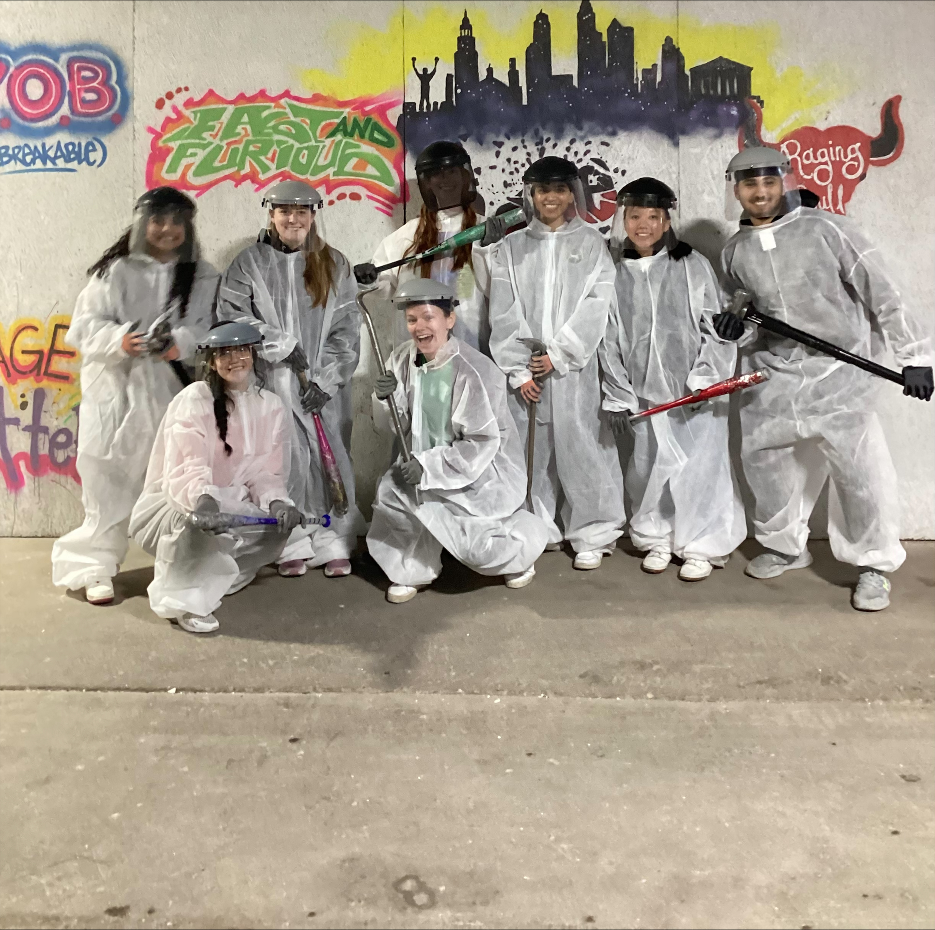 group photo of students in coveralls at rage room