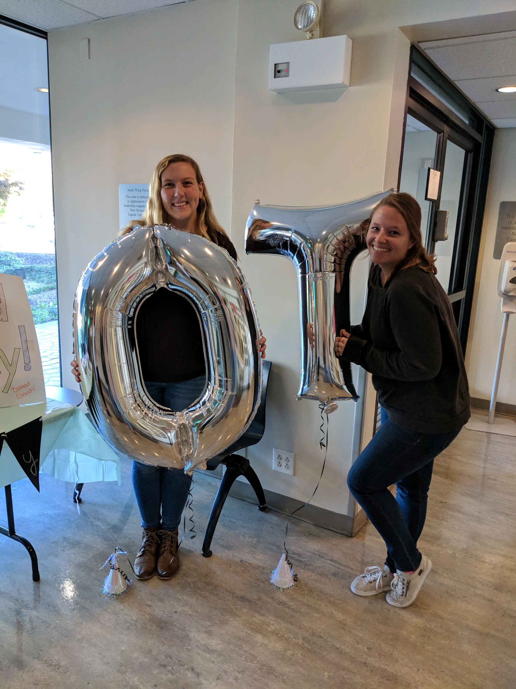 Sara and her friend holding OT balloons
