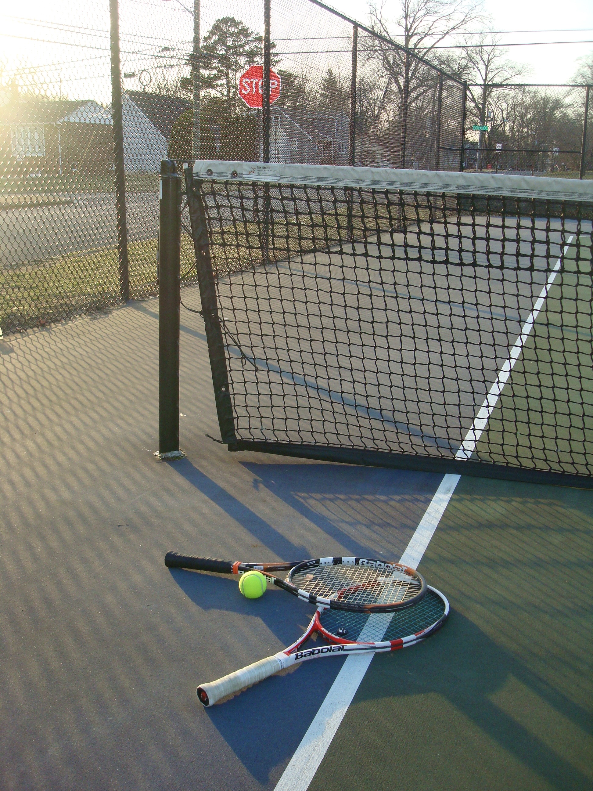 tennis court net and rackets