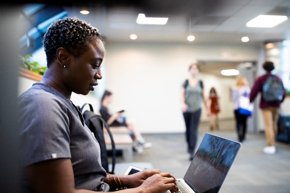 student typing on computer