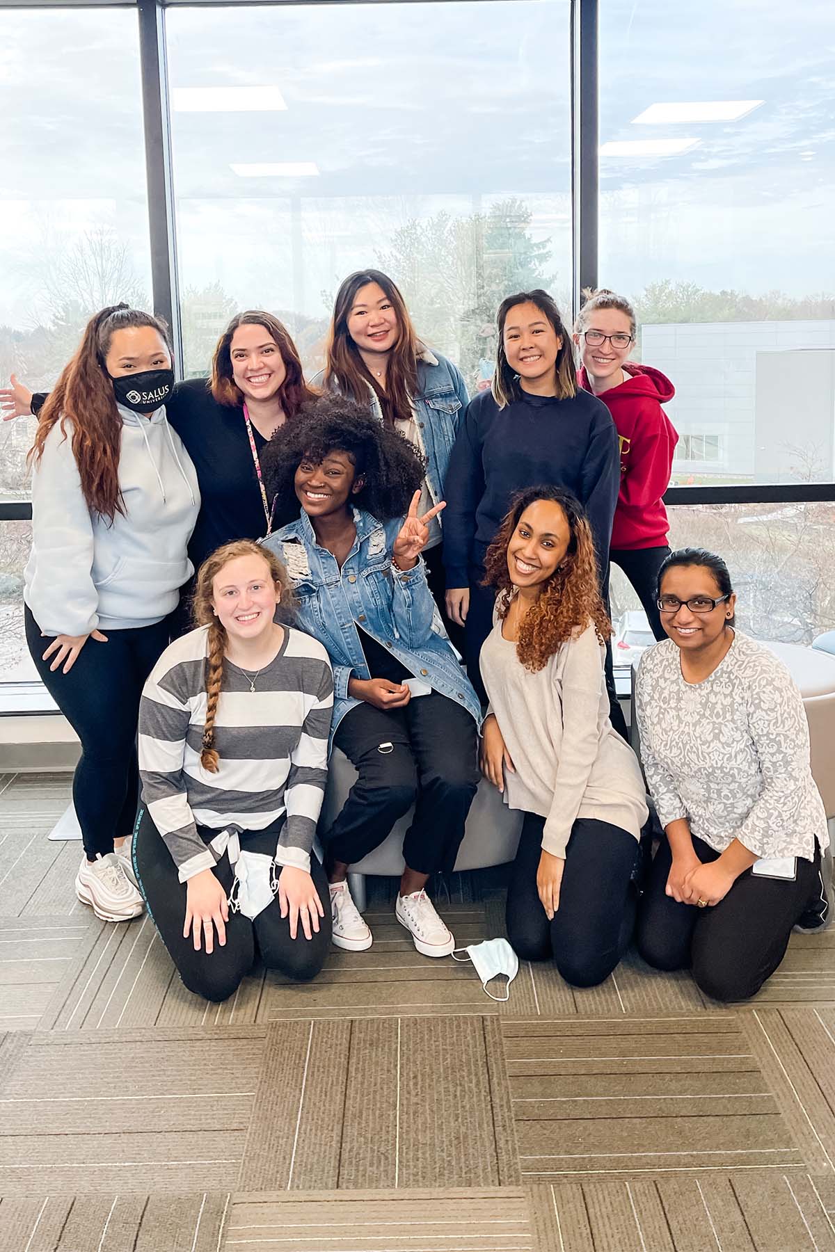 Group photo of Timaj Yusuf with fellow OT students smiling at Elkins Park campus.