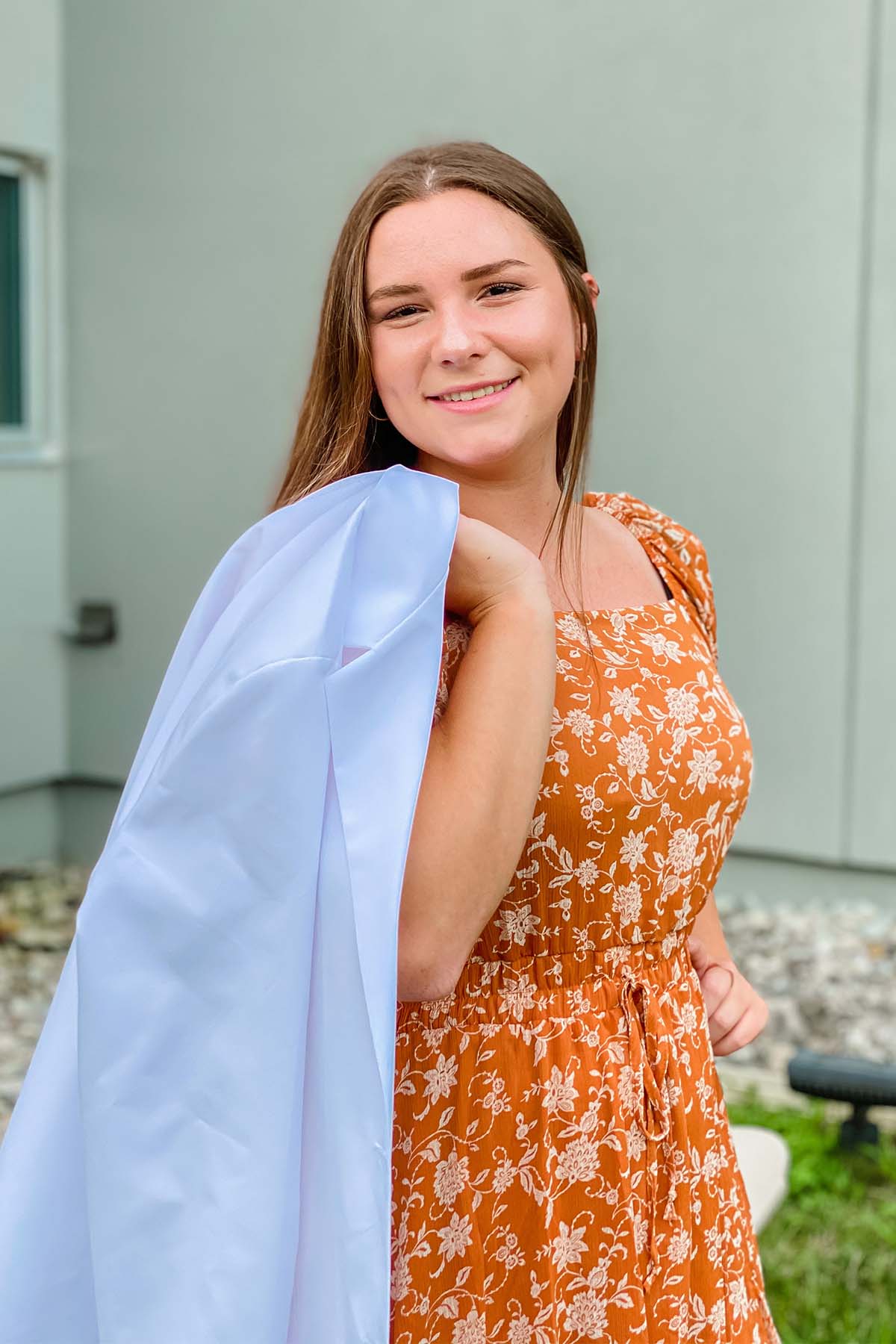  Makenzie Tobin holding white coat over her shoulder