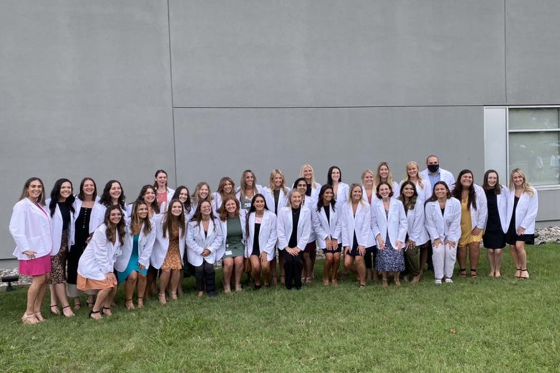 Makenzie Tobin with fellow SLP students in their white coats