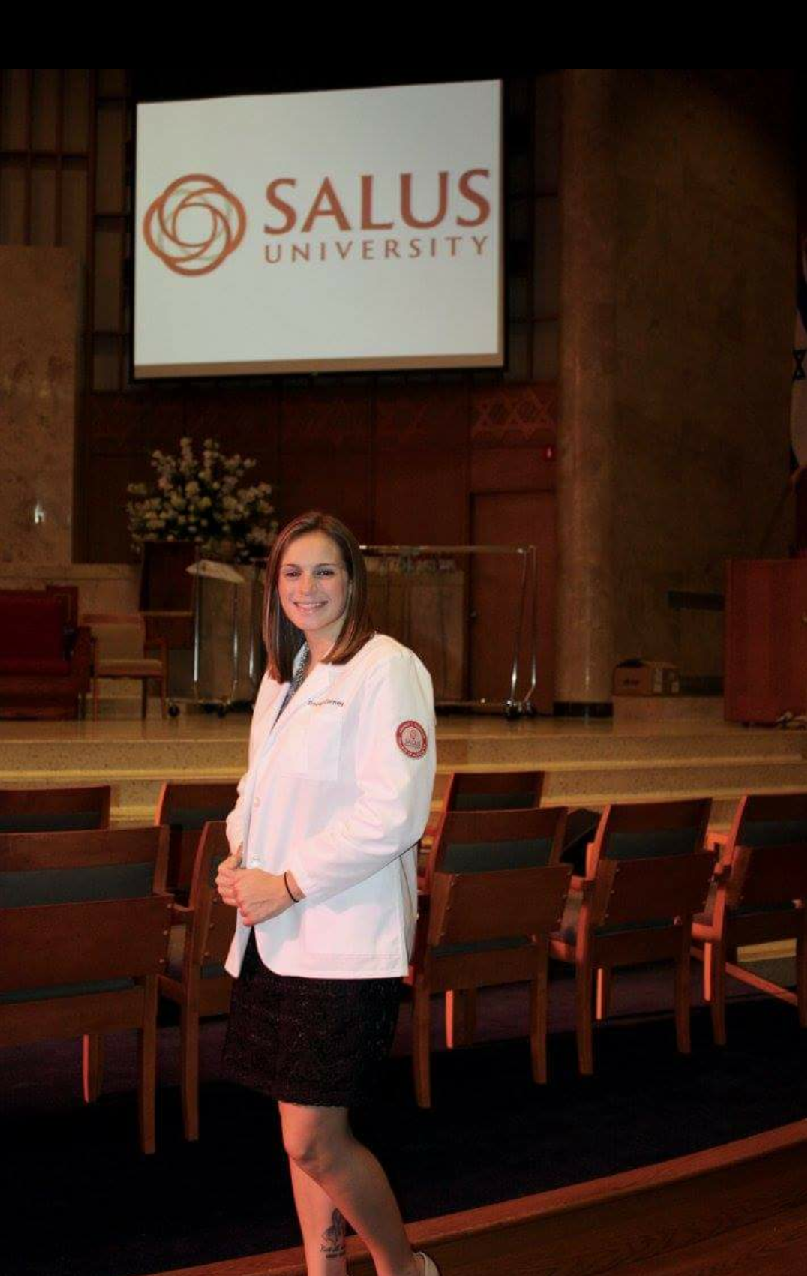 Tracey smiling in her white coat