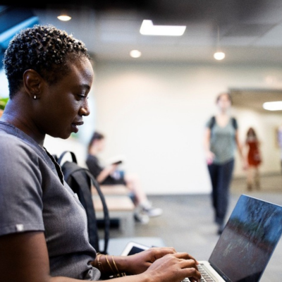 student typing on computer