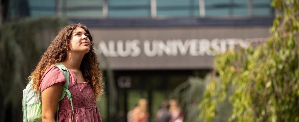 sophie standing in front of Salus main entrance